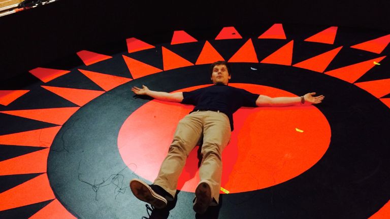 Man lying on black and red floor