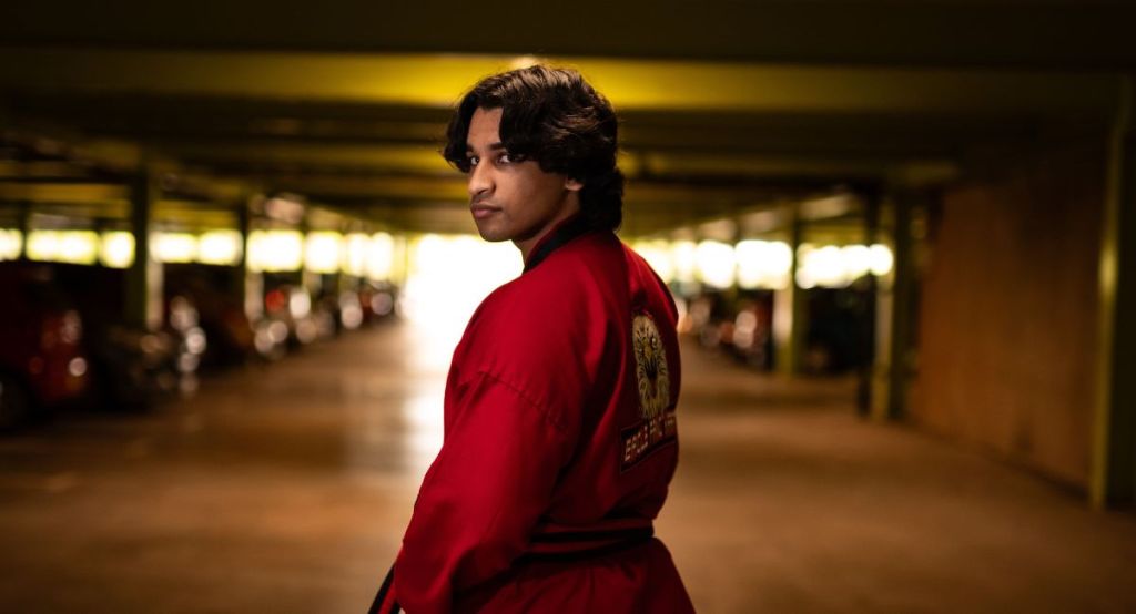 Guy in red karate uniform representing Cobra Kai Nation