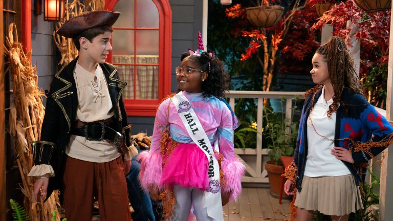 Three kids wearing Halloween costumes